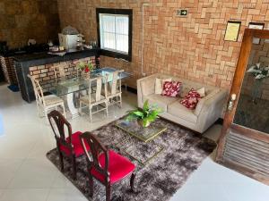 a living room with a couch and a table at Chalé Suíça da Serra in São Benedito