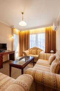 a living room with two couches and a table at Downtown Bansko Resort in Bansko