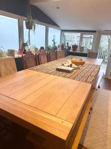 a wooden table in a dining room with a tableablish at The Boho - 4 min walk to beach & town in Bournemouth