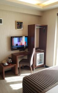 A television and/or entertainment centre at My Liva Hotel