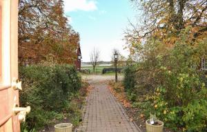 a brick path leading to a house with a church at 2 Bedroom Amazing Apartment In Everöd in Everöd +11 photos
