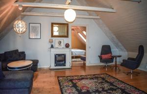 a living room filled with furniture and a fireplace at 2 Bedroom Amazing Apartment In Everöd in Everöd