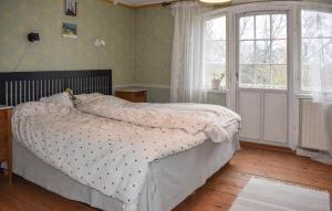 a bedroom with a bed and a large window at 2 Bedroom Amazing Apartment In Everöd in Everöd