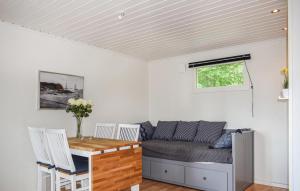 a living room with a couch and a table at 1 Bedroom Lovely Home In Lagan in Lagan