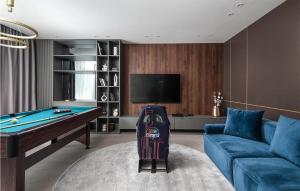 a living room with a pool table and a blue couch at Villa Mowana in Privlaka
