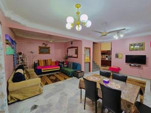a living room with a couch and a table at Homestay LaNik Saujana Utama 2 in Sungai Buluh