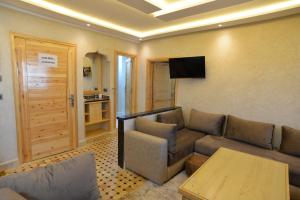 a living room with a couch and a table at Tirazir House 3 in Mirleft