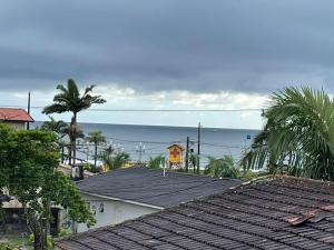 a view of the ocean from the roofs of houses at Casa surf in Guaratuba