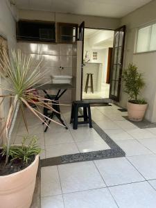 a bathroom with a sink and plants in a room at Suíte 4 Caminho do Mirante in Iguaba Grande