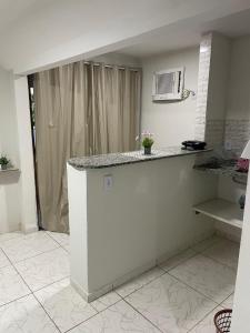 a kitchen with a white counter top in a room at Suíte 4 Caminho do Mirante in Iguaba Grande +7 photos