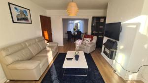 a living room with a couch and a table at Harrogate Entire House, free private parking and garden in Harrogate