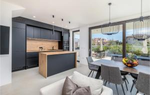 a kitchen and dining room with a table and chairs at 3 Bedroom Gorgeous Home In Pula in Pula