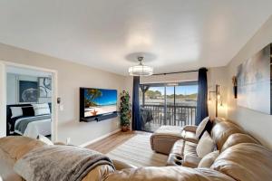 a living room with a couch and a bed at LakeView Fresh and New Bass N Sun King Bed Pool in Clewiston