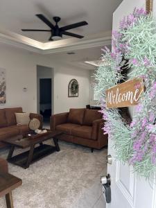 a living room with brown couches and a table at Carroll Estates 3 Bedroom Apartment Retreat in San Juan