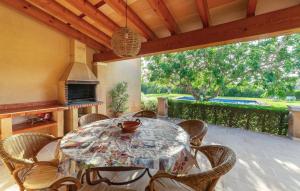 a dining room with a table and chairs on a patio at Can Ullastre in Son Servera