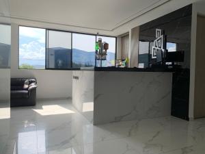 a living room with a counter in a room with windows at Sky Towers in Cúcuta