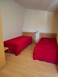 two beds in a small room with red sheets at Maisonette Mountain View - Euphoria Resort in Borovets +7 photos