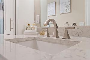 a white bathroom with a sink and a counter at Dockside Serenity in Palm Coast