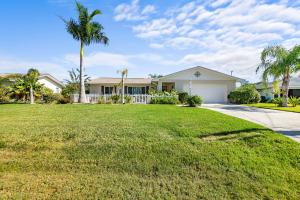 a house with a large yard with palm trees at Dockside Serenity in Palm Coast