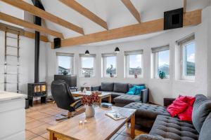 a living room with a couch and a table at Large Holiday Home With Pool And Spa In The Middle Of Blokhus Town, Close To The North Sea in Blokhus