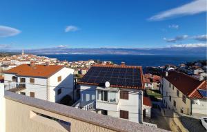 a group of buildings with solar panels on the roofs at 1 Bedroom Beautiful Apartment In Vrbnik in Vrbnik