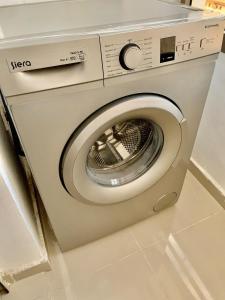 a washing machine sitting in a room with at Downtown apartment in Agadir