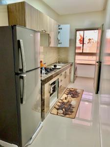 a kitchen with a stainless steel refrigerator and a stove at Downtown apartment in Agadir
