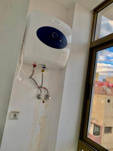 a room with a ceiling fan and a window at Downtown apartment in Agadir +35 photos