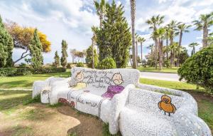 a couch with graffiti on it in a park at Amazing Apartment In Oropesa Del Mar in Oropesa del Mar +11 photos