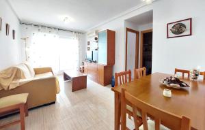 a living room with a table and a dining room at Amazing Apartment In Oropesa Del Mar in Oropesa del Mar