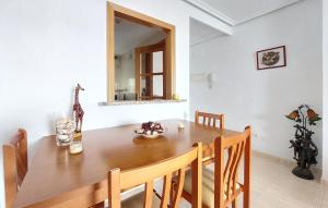 a dining room with a wooden table and a giraffe at Amazing Apartment In Oropesa Del Mar in Oropesa del Mar