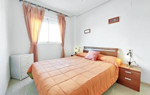 a bedroom with a large bed and a window at Amazing Apartment In Oropesa Del Mar in Oropesa del Mar