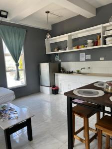 a kitchen with a table and a counter top at Dajon#4-Barkada Generator & starlink in General Luna