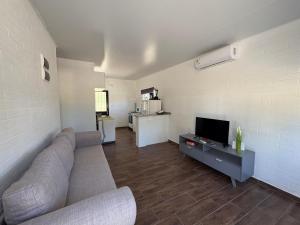 a living room with a couch and a flat screen tv at Complejo San San in San Luis