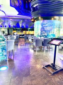 a dining room with tables and chairs in a restaurant at Centara Pattaya Apartment in Pattaya +36 photos