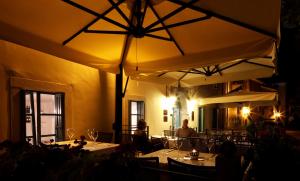 a restaurant with tables and large umbrellas at Boutique Hotel Vela Vrata in Buzet