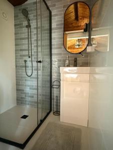 a bathroom with a shower and a sink and a mirror at Jacaranda Cottage 5 min by Train or 7 min drive to Parramatta City in Wentworthville