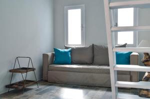 a living room with a couch and a bunk bed at Camara Homes in Andros