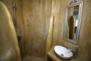 a bathroom with a sink and a mirror at Camara Homes in Andros