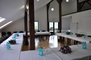 a large room with tables and chairs with flowers on them at Hotel Ieremia Movila in Suceviţa