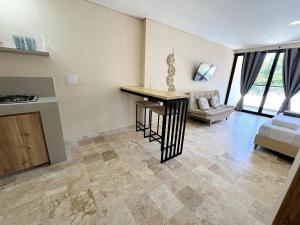a kitchen and living room with a table and a couch at Apartment in Coveñas FOREST in Coveñas