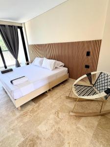 a bedroom with a bed and a chair at Apartment in Coveñas FOREST in Coveñas +6 photos