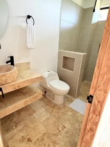 a bathroom with a toilet and a sink at Apartment in Coveñas FOREST in Coveñas