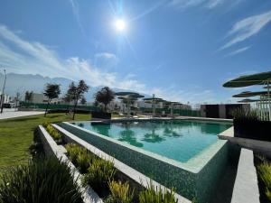 a swimming pool in the middle of a park at Casa súper Equipada Cumbres Dominio in Monterrey