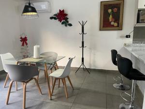 a dining room with a glass table and chairs at Casa súper Equipada Cumbres Dominio in Monterrey +16 photos