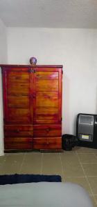 a wooden cabinet in a room with a printer at Habitación al norte de la CDMX aeropuerto Felipe angeles in Mexico City