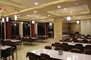 a dining room with tables and chairs in a room at Alexander Hotel in Bethlehem