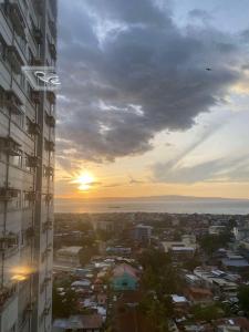 a view of a city from a building with the sunset at Avida Tower Casa De Belladom Staycation in Davao City +13 photos
