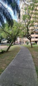 a walkway in a park with trees and a building at Vista Home in Kajang