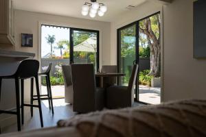 a living room with a table and chairs and a window at Montecito-Chic Beachside Retreat in Montecito